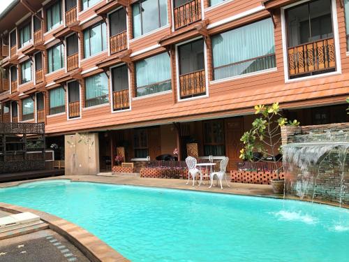 a swimming pool in front of a building at MD House in Chiang Mai