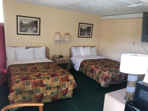 Voodi või voodid majutusasutuse Sunset Motel toas