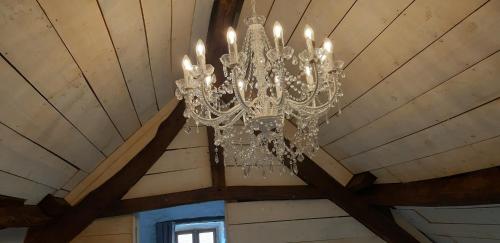 a chandelier hanging from a ceiling in a room at Reids Retreat in La Roche-lʼAbeille