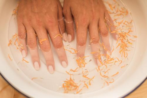 a person with their hands in a plate with parasites at Alpenwellnesshotel St. Veit in Sesto