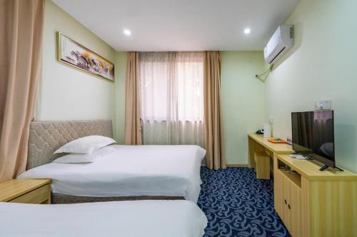 a hotel room with two beds and a television at Hangzhou Memory Travel International Hotel-Edge Westlake in Hangzhou