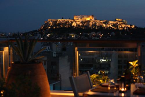 a view of the acropolis at night from a building at Dorian Inn - Sure Hotel Collection by Best Western in Athens