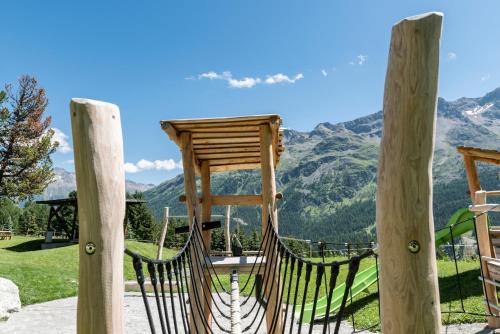 a hammock with a view of mountains at Randolins Familienresort in St. Moritz