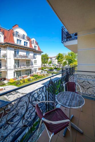a balcony with two chairs and a table on a balcony at Baltic Home in Świnoujście