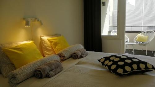 a bedroom with a bed with towels on it at Feels like Home City Holvi in Jyväskylä