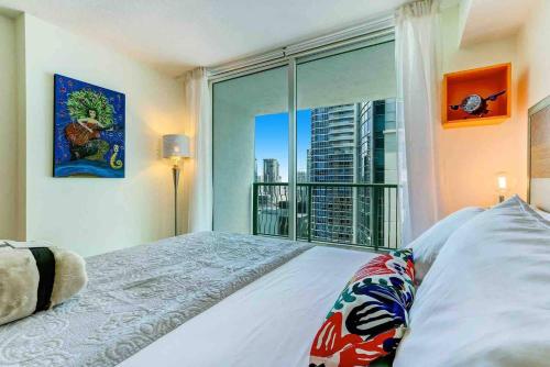 a bedroom with a bed and a large window at 2 Beautiful Apartments in Miami Brickell in Miami