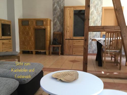 a living room with wooden furniture and a table at Ferienwohnungen An der Bimmelbahn Wernigerode in Wernigerode