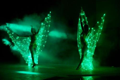two people dancing with lights on their wings at Blue Aegean Hotel & Suites in Gouves