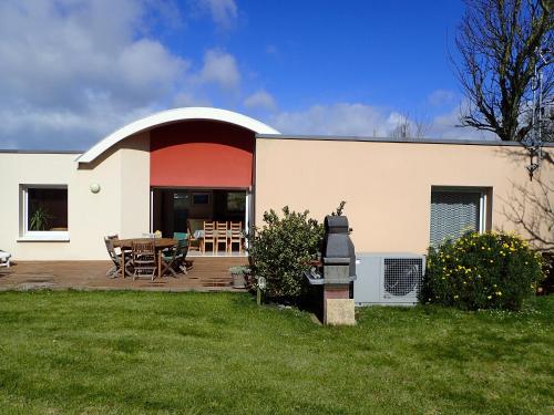 a house with a patio with a table and chairs at Holiday Home Lochrist Le Conquet in Le Conquet