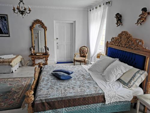 a bedroom with a large bed and a mirror at Château de Verdalle in Verdalle