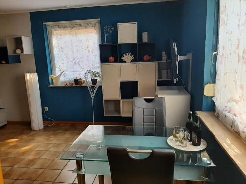 a blue room with a table and a refrigerator at Ferienwohnungen Wittmann in Bad Staffelstein