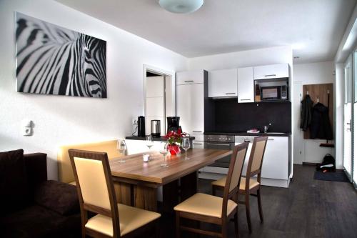 a kitchen with a large wooden table and chairs at TownVille in Flachau