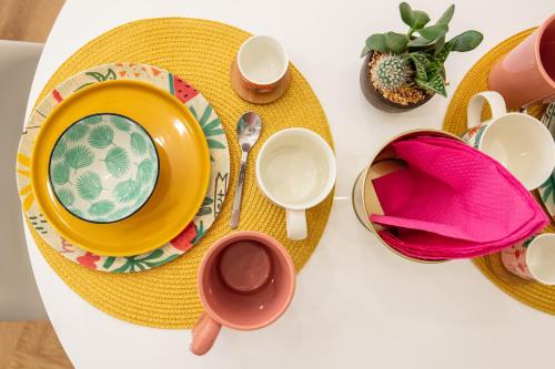 a table topped with plates and cups and saucers at Trastevere 2.0 in Rome