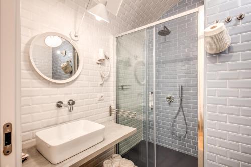 a bathroom with a sink and a glass shower at Trastevere 2.0 in Rome