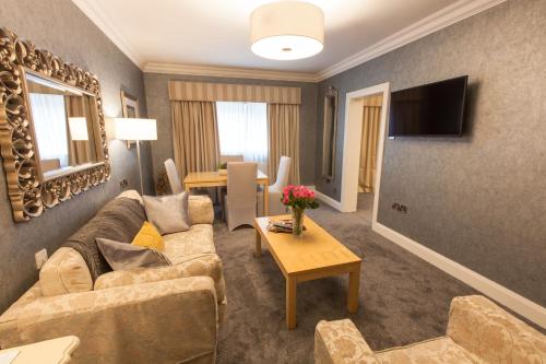 a living room with a couch and a table at Best Western Plus White Horse Hotel in Derry Londonderry