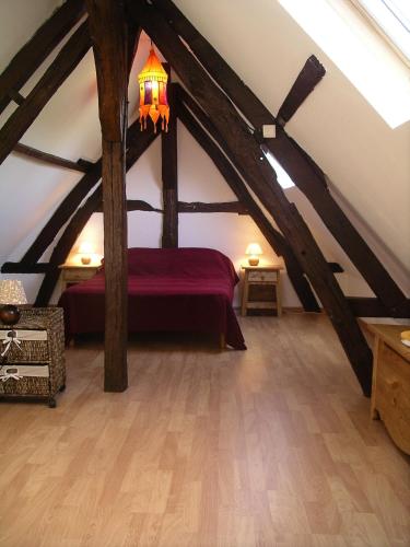 a attic room with a bed in the attic at Gîte du Valcrocq 4/5 pers in Le Bec-Thomas