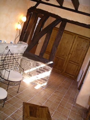 a room with wooden doors and a table and chairs at Gîte du Valcrocq 4/5 pers in Le Bec-Thomas