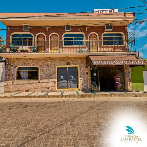 a building on the side of a street at Hotel Posada San Rafael in Barra de Navidad