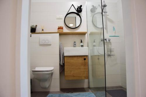 a bathroom with a toilet and a sink and a mirror at sky in Pula