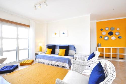 a bedroom with a bed and a table and chairs at Casa Carapau in Ferrel