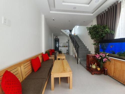 a living room with a couch and a fish tank at Hello Dalat Hostel in Da Lat