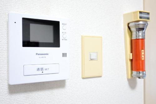 an electronic device with a pen on a wall at Mansion Pasture TSUKISAMU Fukuzumi in Sapporo