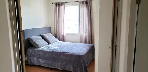 a bedroom with a bed and a window at villa serena 4 Beds, 2 Bath in Rosarito