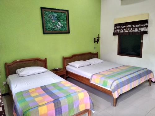 Ένα ή περισσότερα κρεβάτια σε δωμάτιο στο Enny's Guest House