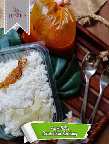 a container of rice and a fork and spoon at Junikastay BLagoon Melaka in Melaka