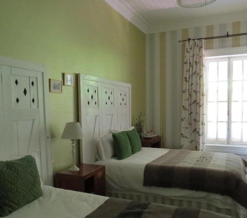 a bedroom with two beds and a window at Hotel Boutique Quinta Maria in Santa Cruz