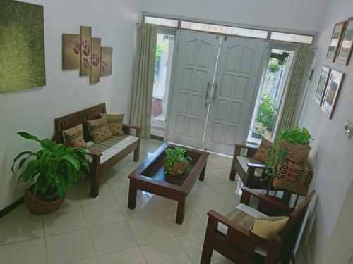 a living room with chairs and a table at Kalandra Guest House in Ponorogo