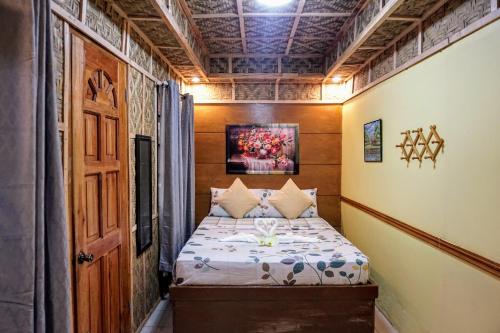 a small bedroom with a bed in a room at Natura Vista in Panglao