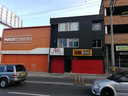 a building on a street with cars parked in front at APARTA ESTUDIO 7051 in Medellín