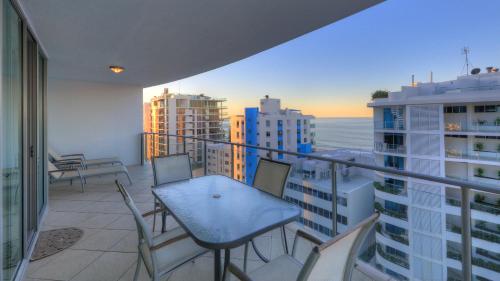 a balcony overlooking a beach with a view of the ocean at Cilento Mooloolaba in Mooloolaba