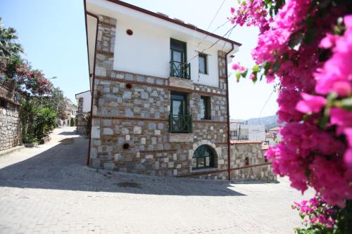 a large stone building with a view of the ocean at Celsus Boutique Hotel in Selçuk