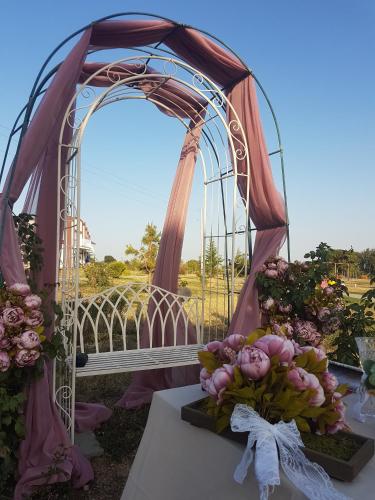 a wedding arch with a bunch of flowers on a table at Апартаментен туристически комплекс Аква Терми in Krasnovo