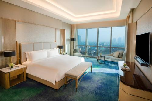 a hotel room with two beds and a television at InterContinental Hotels Jakarta Pondok Indah, an IHG Hotel in Jakarta