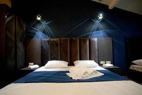 a bedroom with a large bed with lights on it at Hotel City Lights - Tbilisi in Tbilisi City