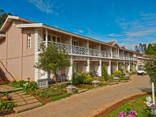 an exterior view of a building at Club Mahindra Derby Green, Ooty in Ooty