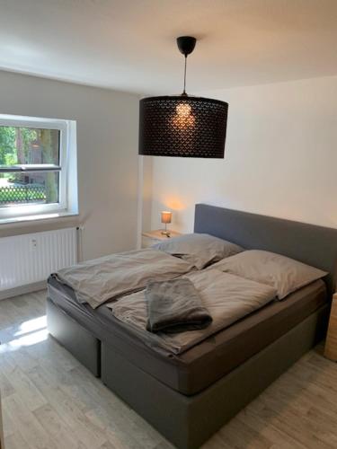 a bedroom with a bed with a lamp and a window at FeWo in Sterkrade in Oberhausen
