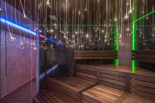 a wooden bench in a room with lights at Innspire Hotel in Munich