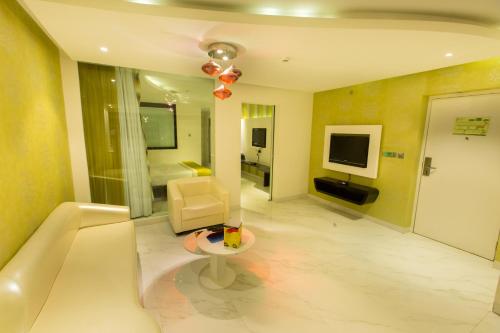 a large living room with a couch and a television at M Inn in Coimbatore
