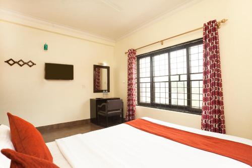 a bedroom with a bed and a large window at Hotel The Holy Birth in Lumbini