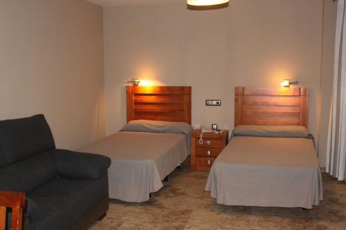 En eller flere senger på et rom på Hotel Peña Escrita