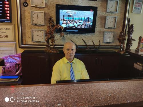 a man in a tie sitting at a desk at Hotel Bazaar in Istanbul