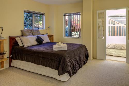 a bedroom with a large bed in a room at Journeys end in Raglan