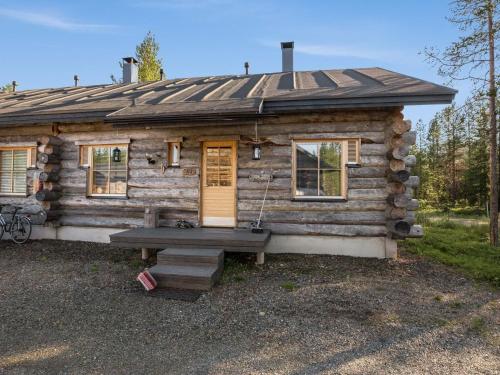 a log cabin with a bench in front of it at Holiday Home Kukasrakka a 4 by Interhome in Äkäslompolo