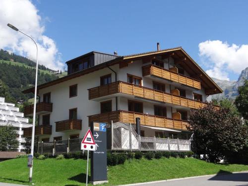 een groot gebouw met een bord ervoor bij Apartment Alpenstrasse 1 by Interhome in Engelberg