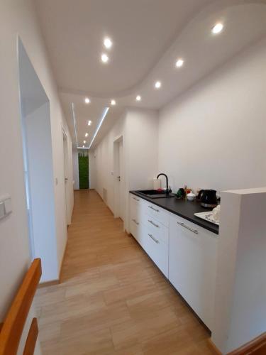 a kitchen with white walls and a counter top at WILLA BAJLAND in Warsaw