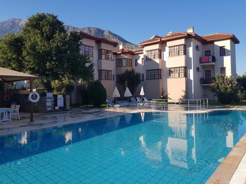 a swimming pool in front of a hotel at Dolphin Apartments in Fethiye